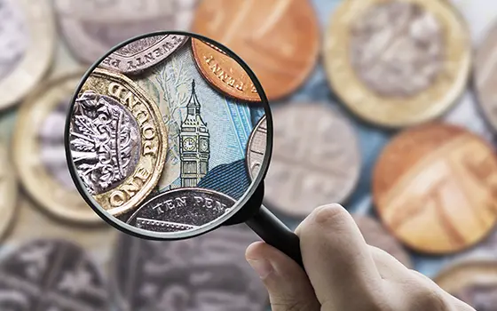 Magnifying glass focusing Great Britain Pound (GBP) currency