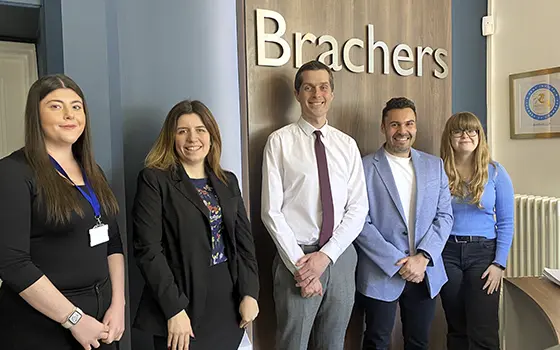 group photo of office staff in Brachers reception area