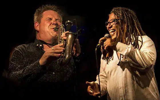 musicians Derek Nash Band and Noel McCalla singing and playing a musical instrument