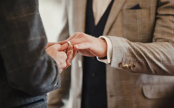 a same sex male couple exchanging rings in a civil partnership