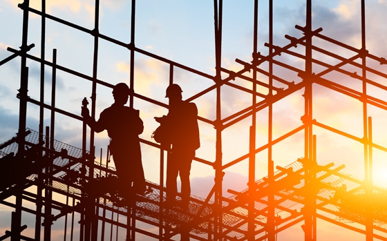Construction Sector - builders on scaffolding