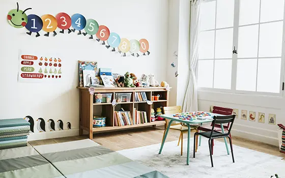 a pre school nursery classroom with a various furniture and decorative items