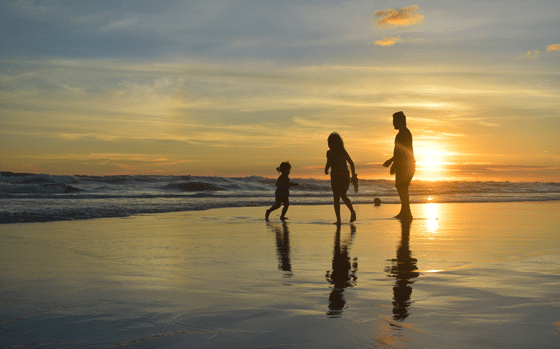 Family on the beach at dusk