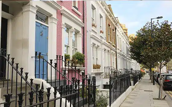 a row of large, colourful terraced houses in a UK street