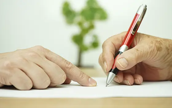 someone signing a document