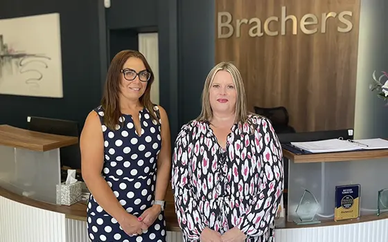 senior associate Miranda Wood and trusts director Justine Sloover standing in Brachers LLP reception area