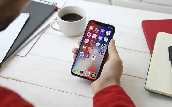 student using a mobile phone at their desk