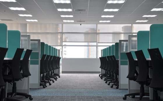 empty office space with desks and chairs