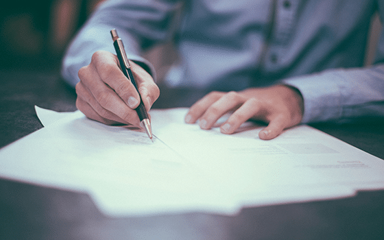a man signing a document